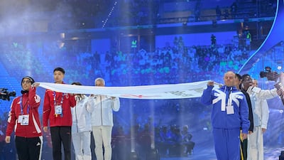 UAE athlete Mina Al Mazrouei raises the Special Olympics flag at the opening ceremony of the World Winter Games. Wam