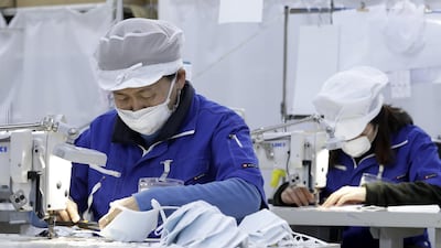 Employees work during the manufacturing of reusable protective masks at the Clever Co. factory in Toyohashi, Aichi Prefecture, Japan. Bloomberg