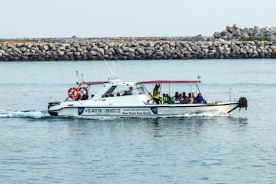 Construction workers are being transported to the island by speedboat. Victor Besa / The National