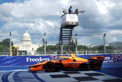 Transport Secretary Sean Duffy and his wife, Rachel Campos-Duffy wave the chequered flags during the Freedom 250 Grand Prix IndyCar Series race in Washington. Reuters