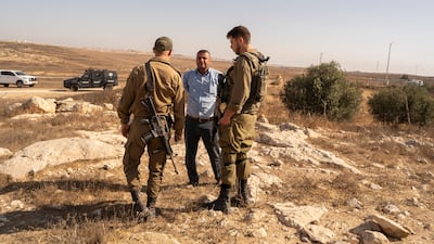 Soldiers confront a member of the community