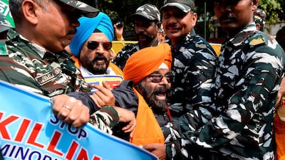 Centre Reserve Police (CRP) detain National Akali Dal President Paramjit Singh (centre) during a protest demanding US President Donald Trump to take action against Pakistan, in New Delhi, ahead of Trump's first official visit to India. AFP