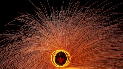 A dancer plays with fire on Chao Lao Beach, in Chanthaburi province, Thailand. Reuters
