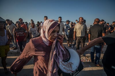 An injured Palestinian woman in the aftermath of the beachside strike at Gaza port. EPA