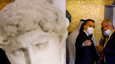 Italian Foreign Minister Luigi Di Maio makes a point about the 3D printed replica of Michelangelo’s David statue at the Italian Expo pavilion. AFP