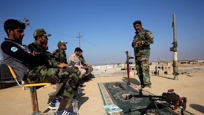 Abbas Hamza Hassan, a 56-year-old Iraqi fighter, is pictured on November 13, 2018 while training fellow Hashed members how to use weapons in the western Iraqi province of Anbar.