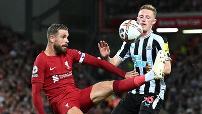 Liverpool's Jordan Henderson battles for the ball with Sean Longstaff of Newcastle. AFP