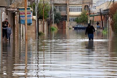 An Iraqi man walks amid a flooded street in Mosul, northern Iraq. EPA