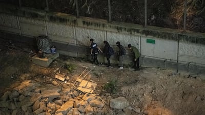 Anti-government protesters attempt to escape Hong Kong Polytechnic University in Hong Kong. Getty Images