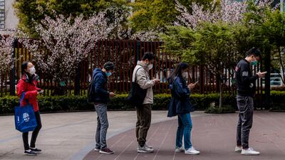 People wait in line to get in to the grocery store, in Shanghai. EPA