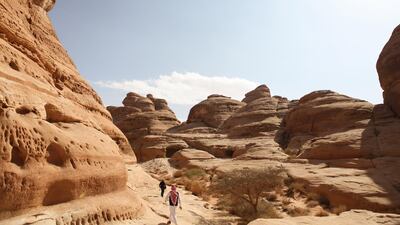 Visitors walk through the ancient rock heritage site at Al Ula, Saudi Arabia. Saudi Arabia's Crown Prince Mohammed Bin Salman officially launched his vision of the mega tourism project at the ancient site of Al Ula. Bloomberg