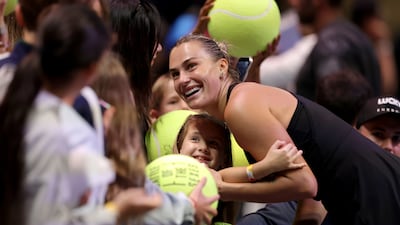 Aryna Sabalenka with a young fan at the Coca-Cola Arena in Dubai. Getty Images