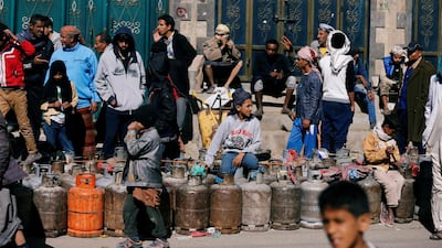 People wait to fill their cooking gas cylinders outside a gas filling station amid a scarcity in cooking gas supplies in Sanaa, Yemen. Khaled Abdullah / Reuters