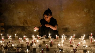 A Shiite girl lights candles during a ceremony marking Ashura, in Hilla, in the central Iraqi province of Babylon. AFP