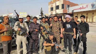 Iraqi security forces and tribal fighters pose for a photograph in central Ramadi, 115 kilometres west of Baghdad, Iraq, on April 16, 2015. AP Photo