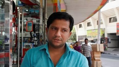 Rashid Navas awaits the arrival of the new Iphone at his shop, Dreams City Electronics, in Bur Dubai.