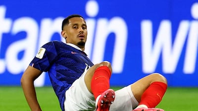 France defender William Saliba sits on the ground after picking up a first-half injury that saw him limp off. Reuters