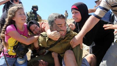 Taken in August 2015 Ahed fights with other members of her family to free her brother held by an Israeli soldier. AFP