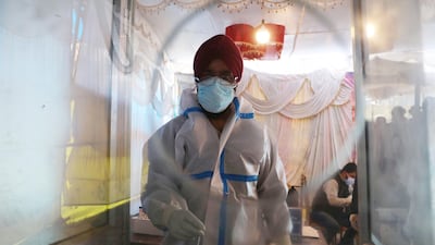 A health worker conducts a Covid-19 test at a test centre in Srinagar, the summer capital of Indian Kashmir. EPA