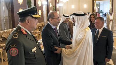 Sheikh Mohammed bin Zayed, Crown Prince of Abu Dhabi and Deputy Supreme Commander of the UAE Armed Forces (R), greets Ayman Safadi, Minister of Foreign Affairs of Jordan (2nd L), during a reception for King Abdullah II, King of Jordan (back R), at the Presidential Airport. They are seen with Queen Rania of Jordan (back). Hamad Al Kaabi / Crown Prince Court - Abu Dhabi