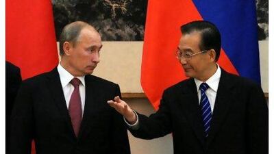 China's premier, Wen Jiabao, right, gestures to the Russian prime minister, Vladimir Putin, during a signing ceremony at the Great Hall of the People in Beijing yesterday. Takuro Yabe / AP Photo