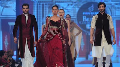 Models present creations by Pakistani designer Mansoor Akram during the first day of the Bridal Couture Week in Karachi on May 9, 2014. AFP