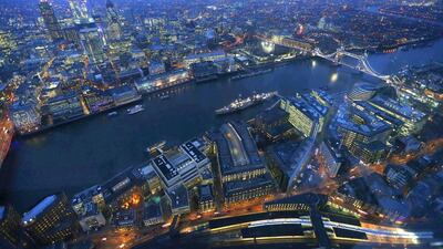 Tower Bridge and the museum warship HMS Belfast are seen at dusk in London. Andrew Winning / Reuters