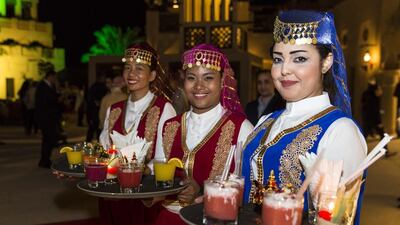 Staff clad in traditional costumes greet guests with an assortment of fresh juices.
