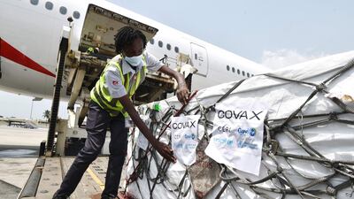 A woman unloads a shipment in the Ivory Coast which has received 504,000 doses of AstraZeneca Covid-19 vaccine. AFP.