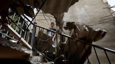 Mohammad Awad's home in Hermel in north-east Lebanon was damaged by a rocket fired from Syria on Wednesday that also killed his sister. Hussein Malla / AP Photo