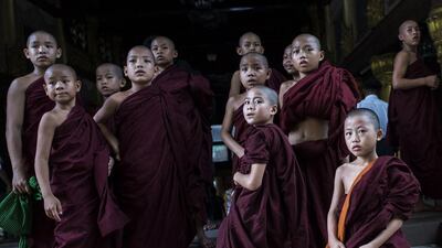 Buddhist novices watch the ninth anniversary of Saffron Revolution ceremony at Shwedagon pagoda in Yangon. The Saffron Revolution is a protest led by tens of thousands of monks against high fuel prices that took place in 2007 in Yangon. AFP