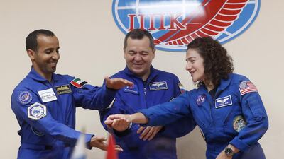 The team clap their hands together in a show of solidarity at their final public event before blast off on Wednesday. EPA