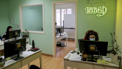 Embrace staff work at their desks in Beirut. EPA