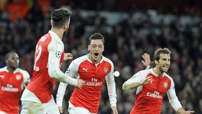 Mesut Ozil of Arsenal celebrates his opening goal for the club on Tuesday night in the Champions League. Gerry Penny / EPA