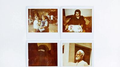 School girls, local artisans and a man pose for portraits in the Heritage Village in Abu Dhabi.