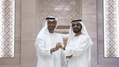 Sheikh Mohammed bin Rashid and Sheikh Mohamed bin Zayed meet in the Vice President's wing of Qasr Al Watan earlier this month to sport Expo 2020 wristbands. The two leaders and 500 other top government officials are meeting in in the capital on Monday. Mohamed Al Hammadi / Ministry of Presidential Affairs