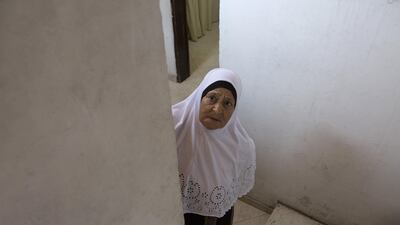 Fatima Shamasneh looks towards the street from the stairs of her her tiny basement home in the East Jerusalem neighbourhood of Sheik Jarrah. Heidi Levine for The National