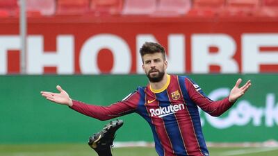Barcelona defender Gerard Pique pleads his innocence as Sevilla's Luuk De Jong holds his head. AFP