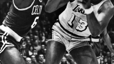 In this May 5, 1969, file photo, Los Angeles Lakers' Wilt Chamberlain tries to shoot against Boston Celtics' Bill Russell during an NBA basketball finals game at the Forum in Los Angeles. AP