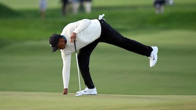 Tiger Woods holes out on the ninth green. USA Today