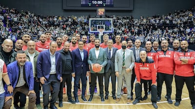 Syrian President Ahmad Al Shara poses with officials and players of the Lebanese national basketball team at the reopening of the renovated Al Fayhaa Sports Hall in Damascus. Photo: Syrian Presidency