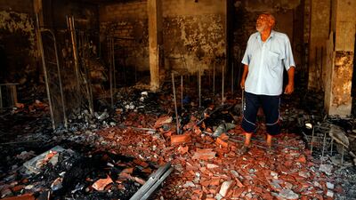 A man surveys the damage from clashes in the Libyan capital of Tripoli. AP