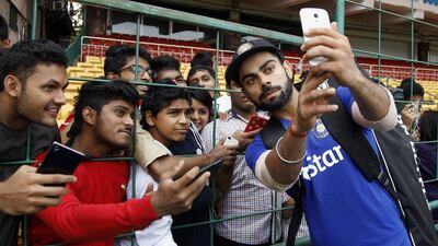 India’s Virat Kohli takes a selfie with fans after attending a training session on Thursday ahead of the second Test against South Africa. Aijaz Rahi / AP