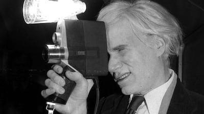 The filmmaker Andy Warhol poses with one of Polaroid’s film cameras, the Polavision camera, which featured instant replay on television screens, in 1978. Dave Pickoff / AP Photo