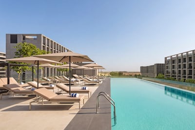 The hotel’s infinity pool overlooks the surrounding Aljada neighbourhood. Photo: Vida Aljada