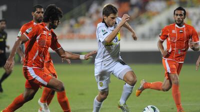 Ajman's defence struggles to cope with another Wasl surging run. Afsal Sham