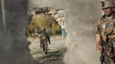 Security personnel patrol guard near a hole in a wall made to rescue people from the Shamshad TV building after a deadly attack in Kabul, Afghanistan, Tuesday, November 7, 2017. Massoud Hossaini / AP