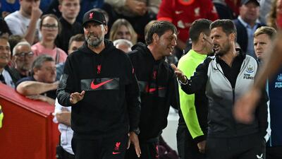 Liverpool manager Jurgen Klopp argues with Newcastle assistant coach Jason Tindall during the first half. AFP