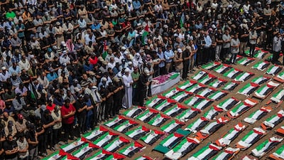 Palestinians gather during a mass funeral for 112 members of the Abu Sharia and Al-Hasayna families in the eastern Gaza City. EPA