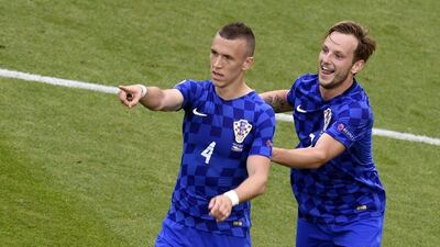 Croatia midfielder Ivan Perisic celebrates with Croatia’s midfielder Ivan Rakitic following a goal during the Euro 2016 Group D football match between Czech Republic and Croatia at the Geoffroy-Guichard stadium in Saint-Etienne on June 17, 2016. Jean-Philippe Ksiazek / AFP